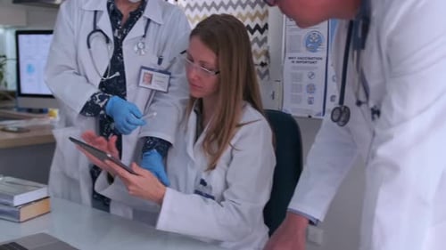 Medical Team Discussing Results on Tablet