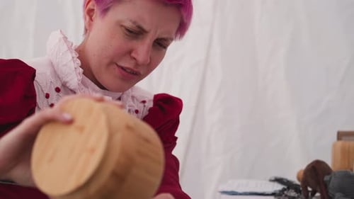 Person Crafting Detailed Wooden Vessel in Studio