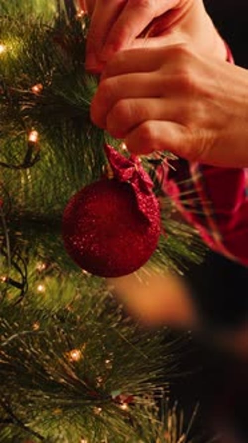 Hands Decorate Christmas Tree with Ornament, Holiday Season
