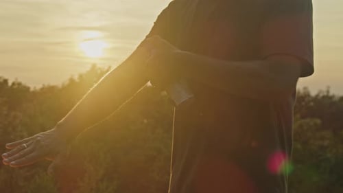 Man Shields From Mosquitoes with Repellent Spray on Mountain