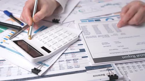 Accountant Calculates Financial Report with White Calculator