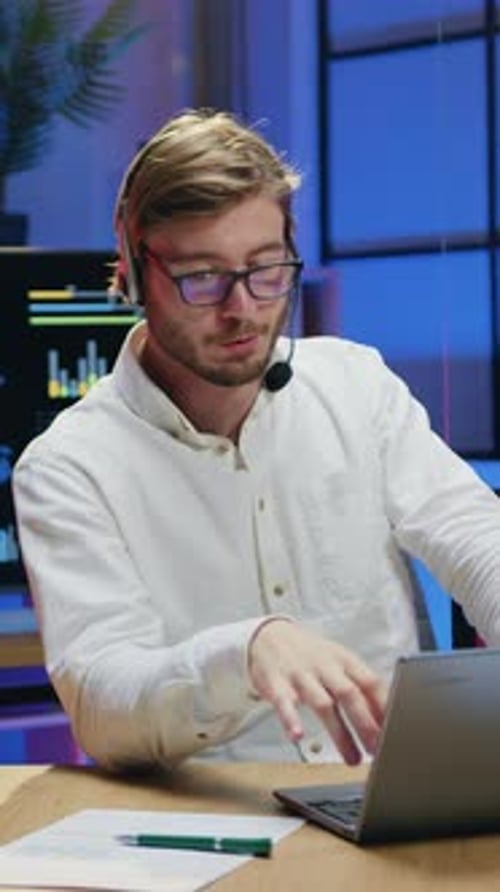 Young Man Video Conferencing in Office at Night