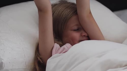 Blonde Girl Waking up and Stretching in Bed
