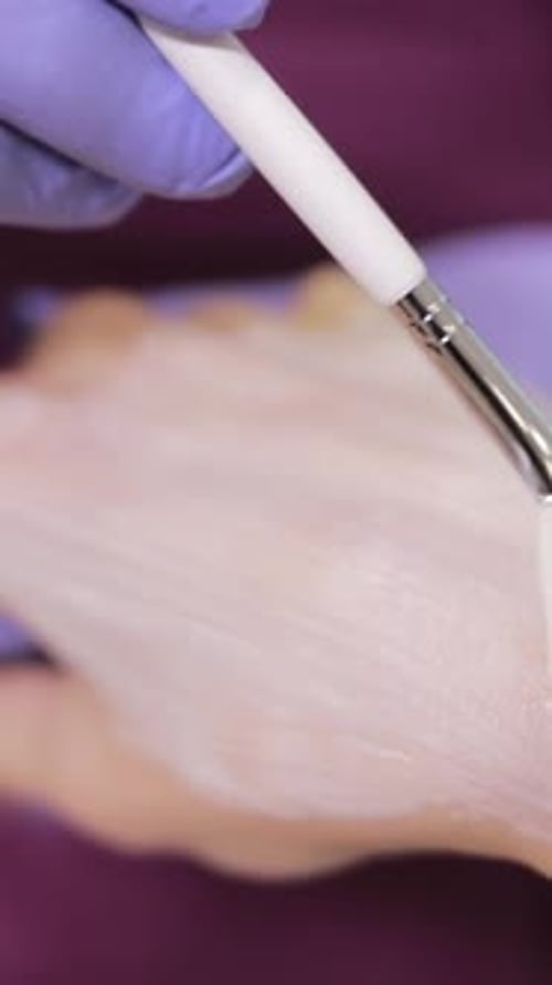 A Woman is Getting a Facial Treatment on Her Hand Vertical Video