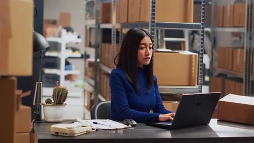 Young Adult Working on Retail Stock Orders in Depot