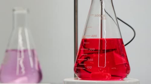 Red Liquid Mixing in Chemistry Laboratory