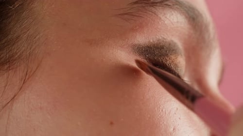 Eye Shadow Makeup to the Upper Eyelid Closeup Makeup Artist Applies a Bright Eye Shadow with a