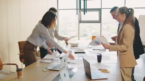 A Team of Business Professionals is in a Contemporary Office Engaging in Discussions Brainstorming