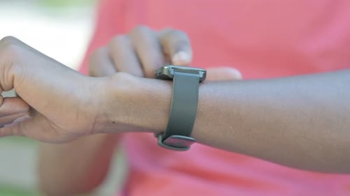 Close up of African Man Using Smartwatch Outdoor