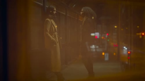 Two Women Talking at Night in City