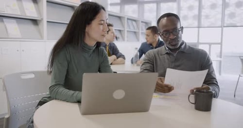 Colleagues Working on a Business Presentation Together in Office
