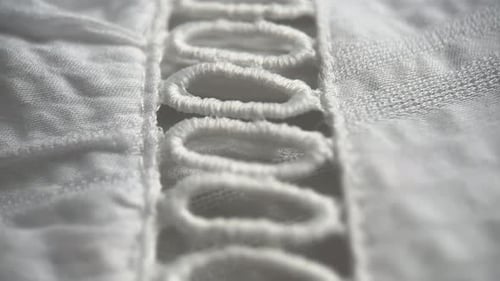 Close Up of Textured White Fabric with Embroidery
