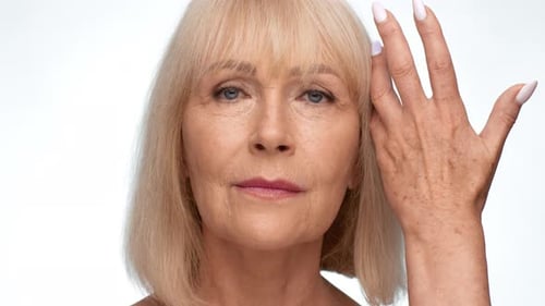 Senior Woman Touching Her Face