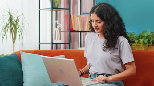 Young Woman Freelancer Sitting on Couch Close Laptop Pc After Finishing Work in Living Room at Home