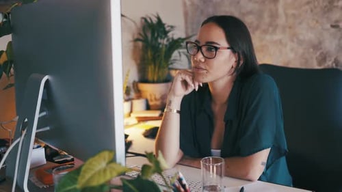Young Woman Working on Computer in Modern Office