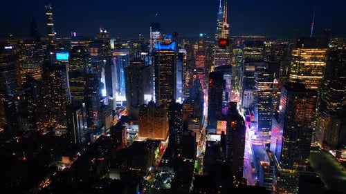 Bright light on the street at the foot of skyscrapers. Never sleeping New York filled