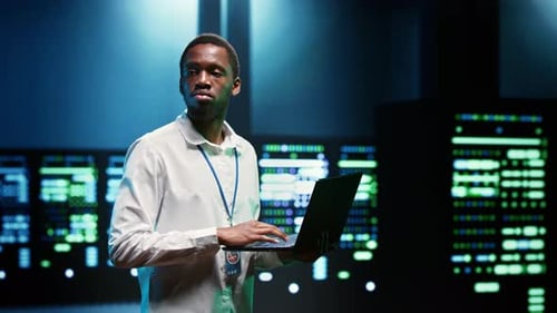 African American IT Developer Inspecting Electronics Inside Data Center