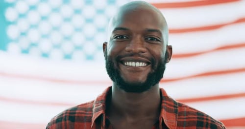 Man Smiling in Front of American Flag