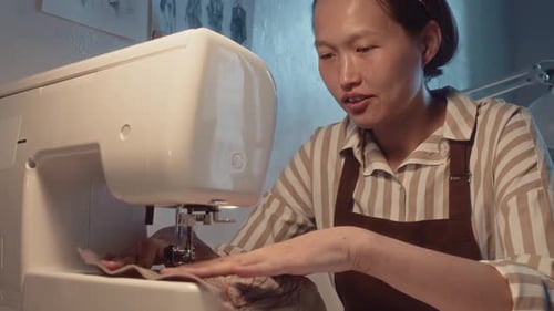 Woman Sewing on Sewing Machine