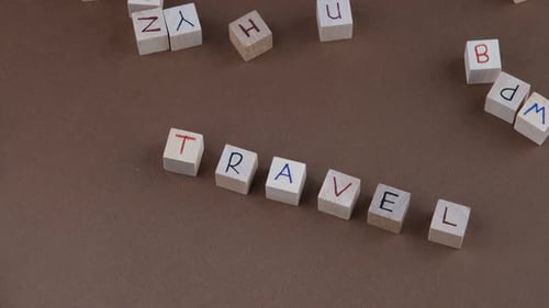 Wooden Blocks Spell Out the Word Travel