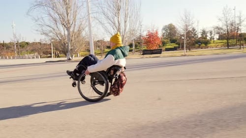 Young Person Enjoying Freedom and Mobility in Wheelchair at Park