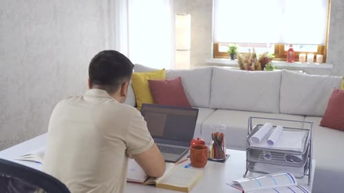 Adult Man Studying and Working from Home