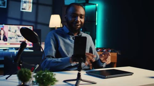 Young adult talking to the camera about laptop