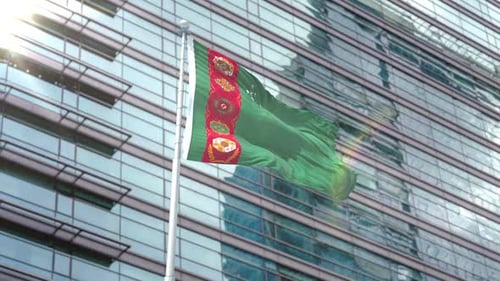 Turkmenistan National Flag Waving with Modern Building Background