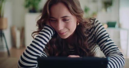 Woman Using Tablet Device at Home