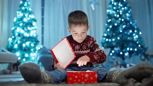 Excited Boy Opens Christmas Gift at Home