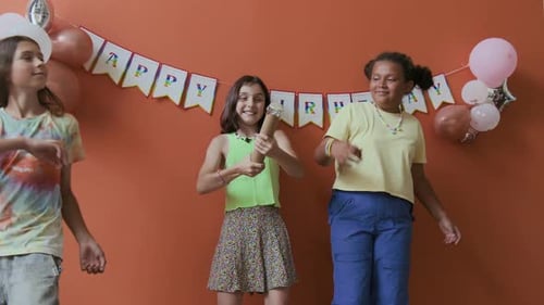 Birthday Girl Blowing up Party Popper Enjoying Confetti Rain with Friends