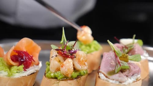 Making Antipasto Bruschetta Baguette Slices Topped with Tomatoes Basil Mixed Sauce Prawns Salmon and