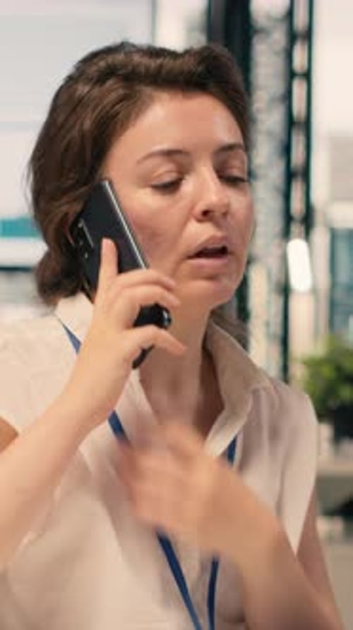 Vertical Video Businesswoman Making Phone Call in Modern Office Reviewing Visual Data
