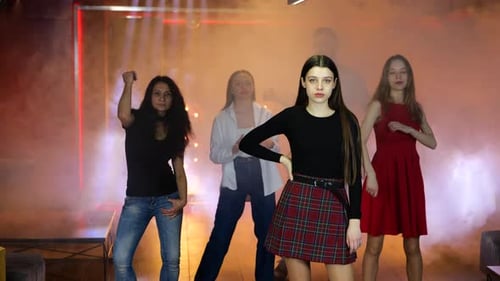 Young Adults Dancing in Nightclub with Hazy Lighting