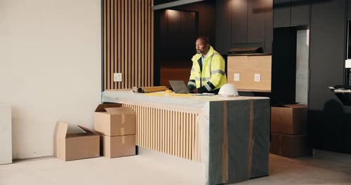 Laptop, planning and renovation with black man in kitchen for home improvement or upgrade project