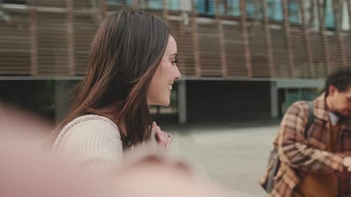 Student filming a stream with her friends on a mobile phone