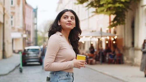 Happy Indian Woman Enjoying Drinking Morning Coffee Hot Drink Relaxing Taking a Break on City Street
