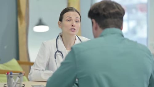 Female Doctor Talking with Patient in Clinic