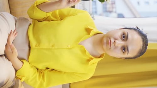 Young Woman in Yellow Shirt Gestures to Camera