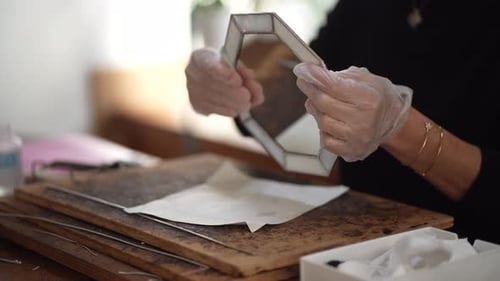 Woman Assembling Glass Art at Workbench