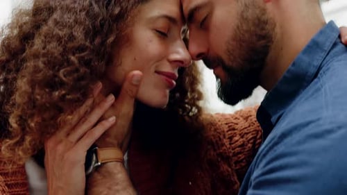 Loving Couple Embracing Indoors with Foreheads Touching