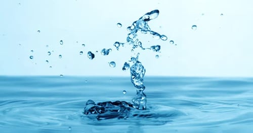 Drop of water falls into a drop of water in a super slow motion. Shot on super slow motion 1600 fps.