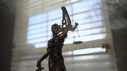 Lady Justice Statue on Foggy and Light From Windows on Background Move Camera