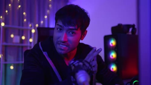 Young Adult Speaks into Microphone Bathed in Neon Light