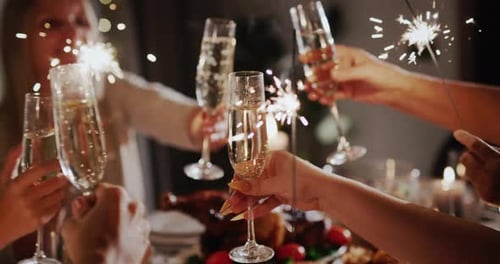Friends Celebrate with Champagne and Sparklers at Table