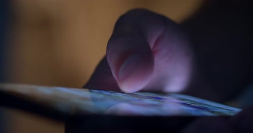 Finger Taps On Smartphone Touchscreen At Night