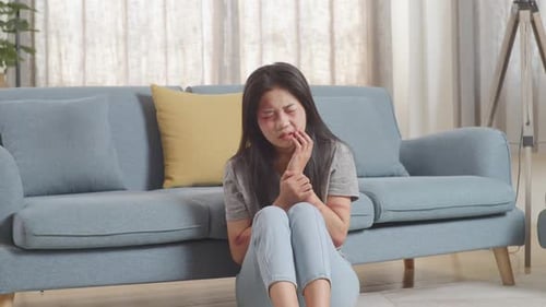 Woman Victim Of Violence Sitting On The Floor And Touching Bruise On Her Body From Physically Abused