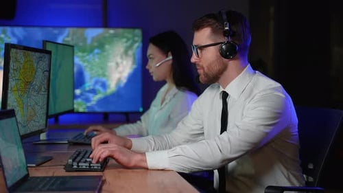 Tired Man Working Late in Office with Colleague