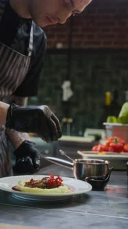Slow Motion Chef Sprinkling Garnish Plating Food in Restaurant Kitchen