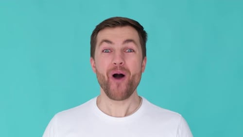 Man With Excited Expression On Blue Background